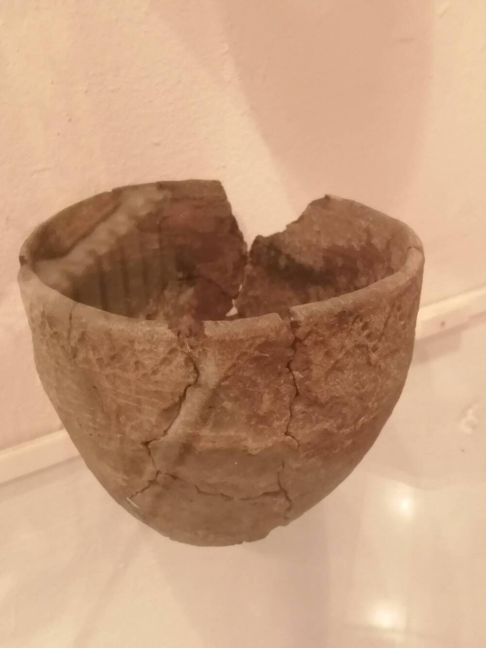 Горшок глиняной ручной лепки с отогнутой шейкой. Орнаментирован.