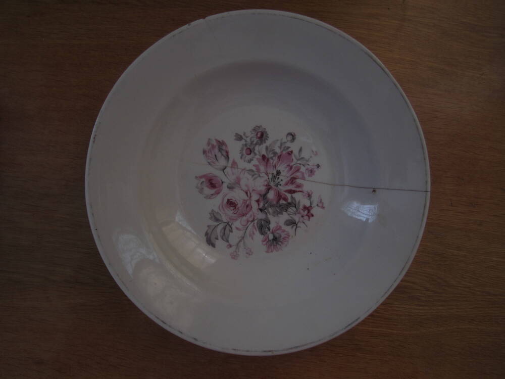 Тарелка глубокая белого цвета. На зеркале тарелки - цветы розового и серого цвета 1950-е гг.
