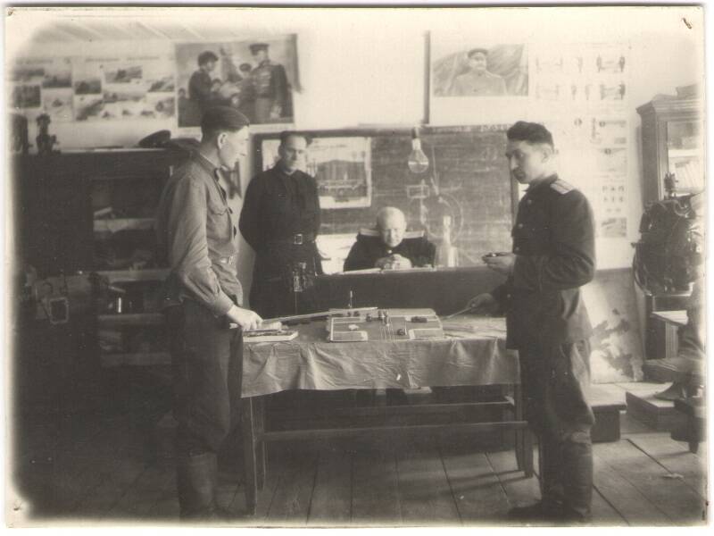 Фотография черно-белая учебного кабинета во время выпускных экзаменов в автошколе.