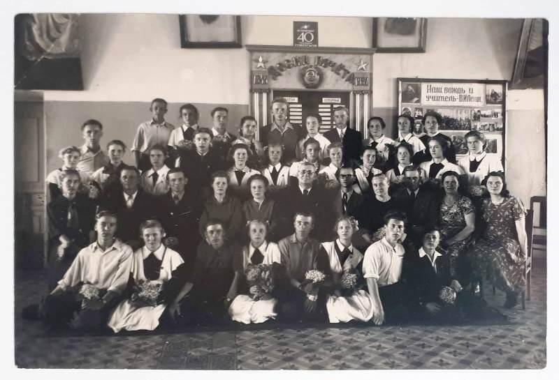 Фотография. Выпускники 10 «А» класса школы № 9 города Аткарска с директором и учителями возле доски почёта