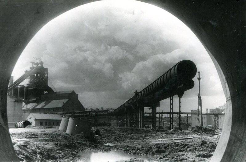 Фотография черно-белая. Вид на домну из трубы газопровода