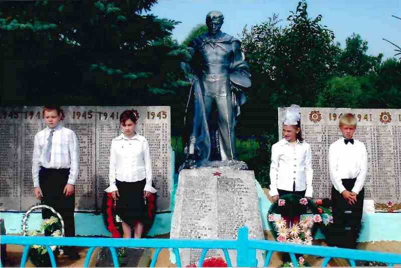 Фото цветное. Дети у братской могилы на мероприятии в честь 66-ой годовщины освобождения от немецко-фашистских захватчиков с. Подмаслово.