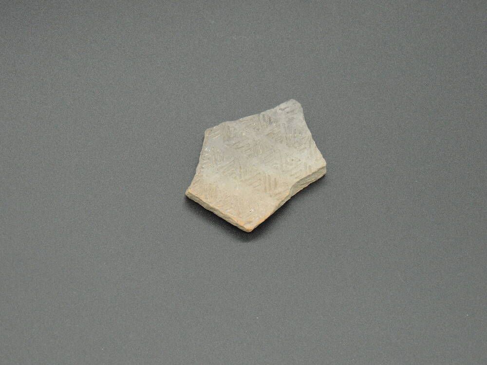 Фрагмент керамики с орнаментом в виде полос и оттисков овалов