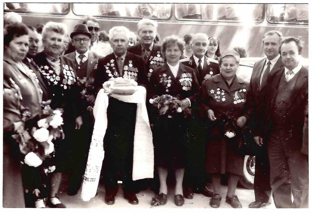 Фотография черно-белая, групповая. На фоне автобуса изображены ветераны ВОВ 