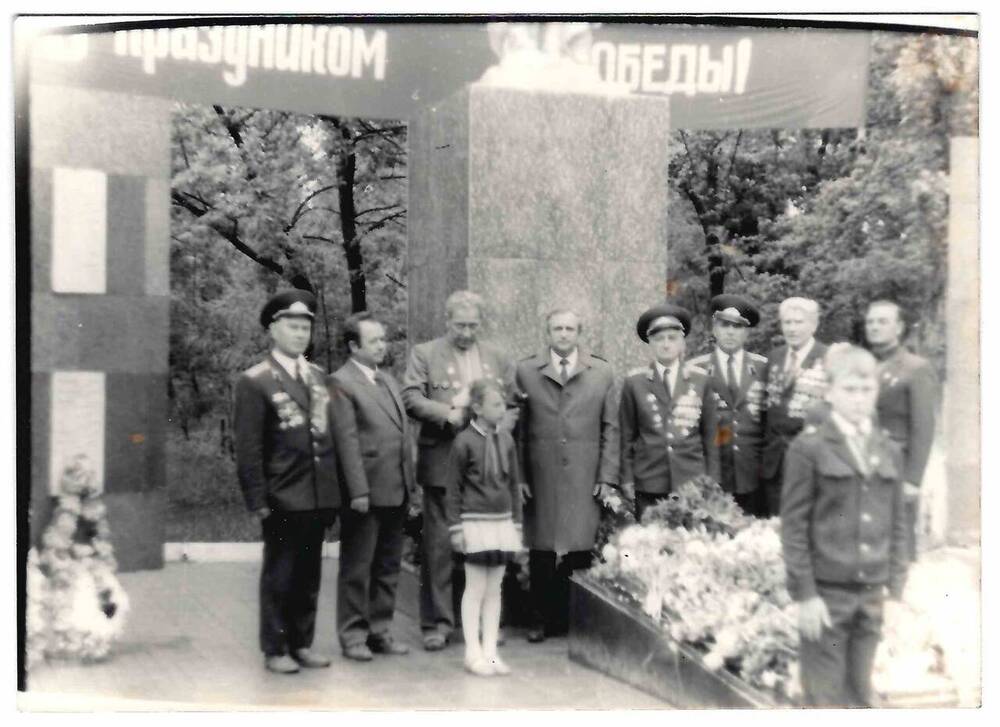 Фотография черно-белая групповая, выполнена у памятника в селе Киевском.