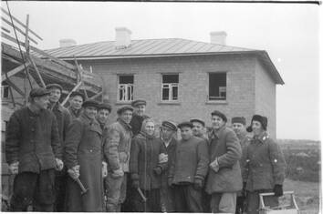 Группа рабочих на фоне строящегося «Дома молодоженов» завода им.В.И.Ленина
