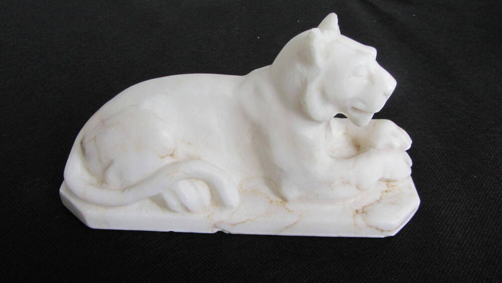 Скульптура малых форм в виде лежащей львицы.
